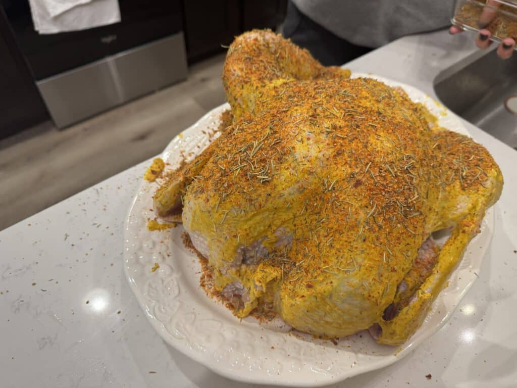 Adding Rub to Smoked Turkey on a Pellet Grill