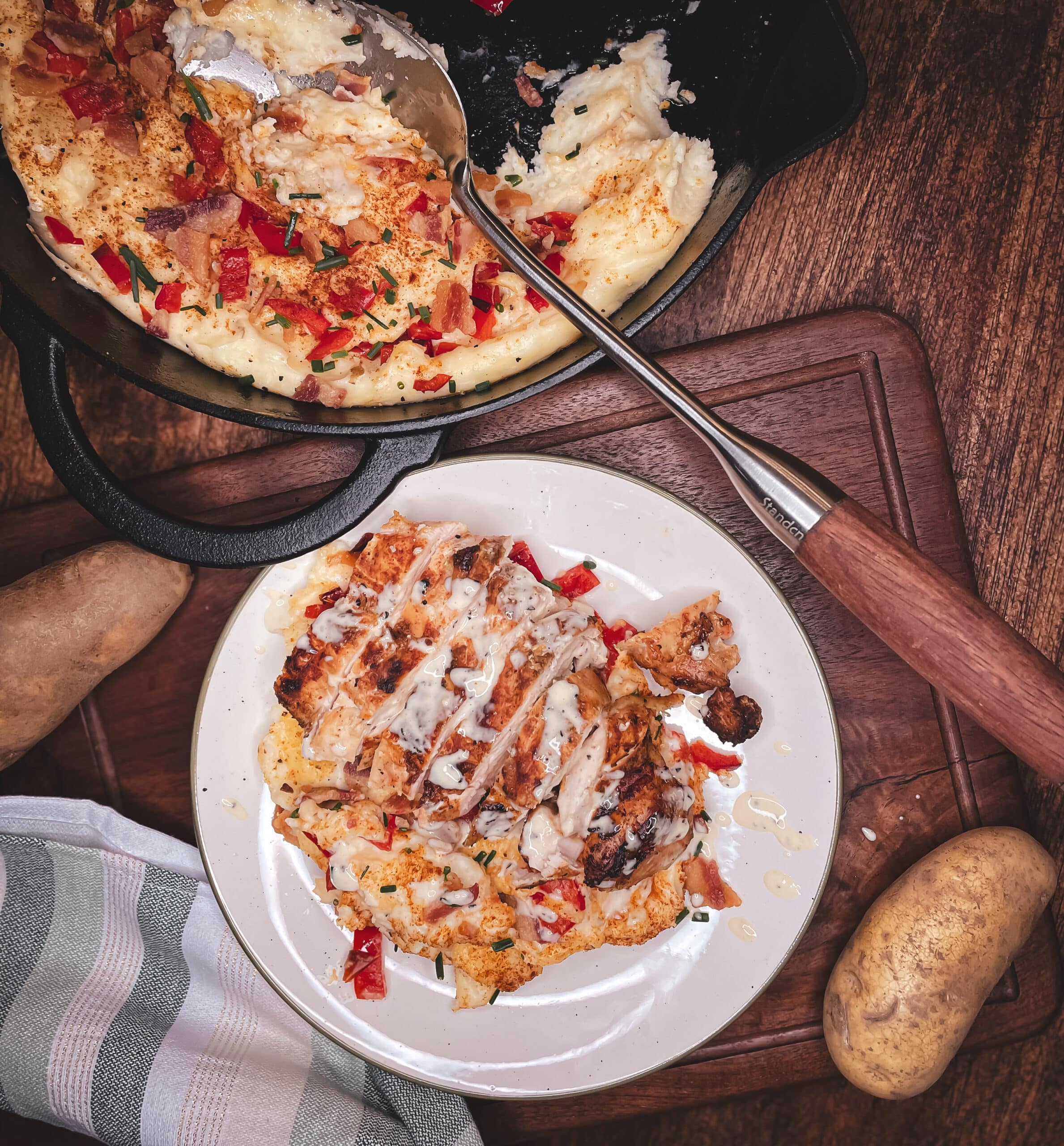 Alabama White Sauce Chicken on a white plate by mashed potatoes