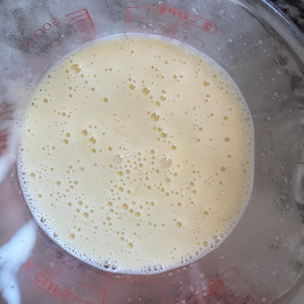 White Broccoli Salad Dressing in Clear Bowl