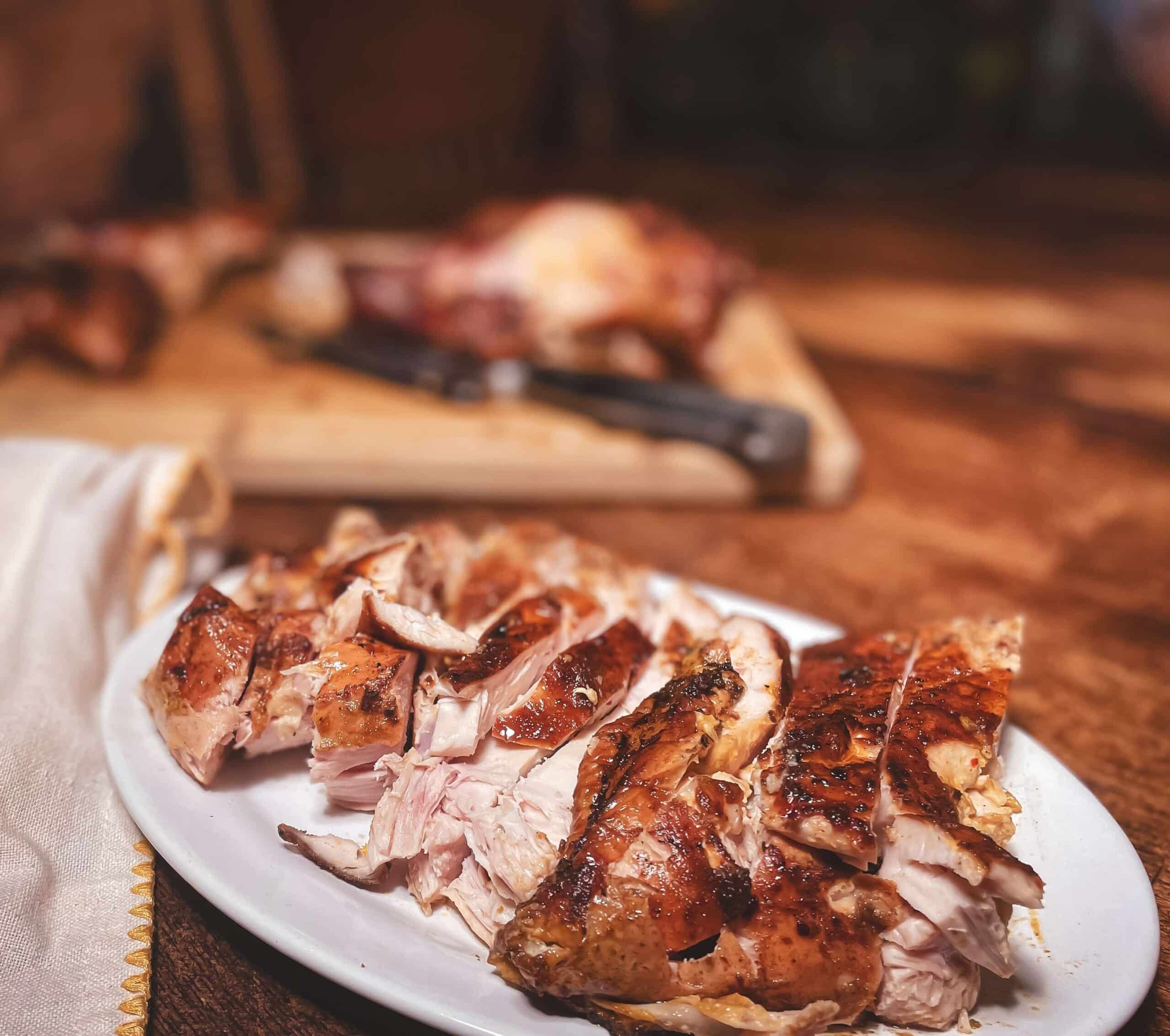 Sliced smoked chicken on a white plate