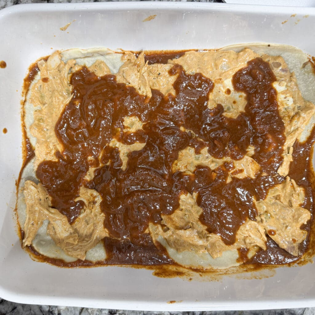 Sauce on First Layer of Chicken Enchiladas with Cream Cheese