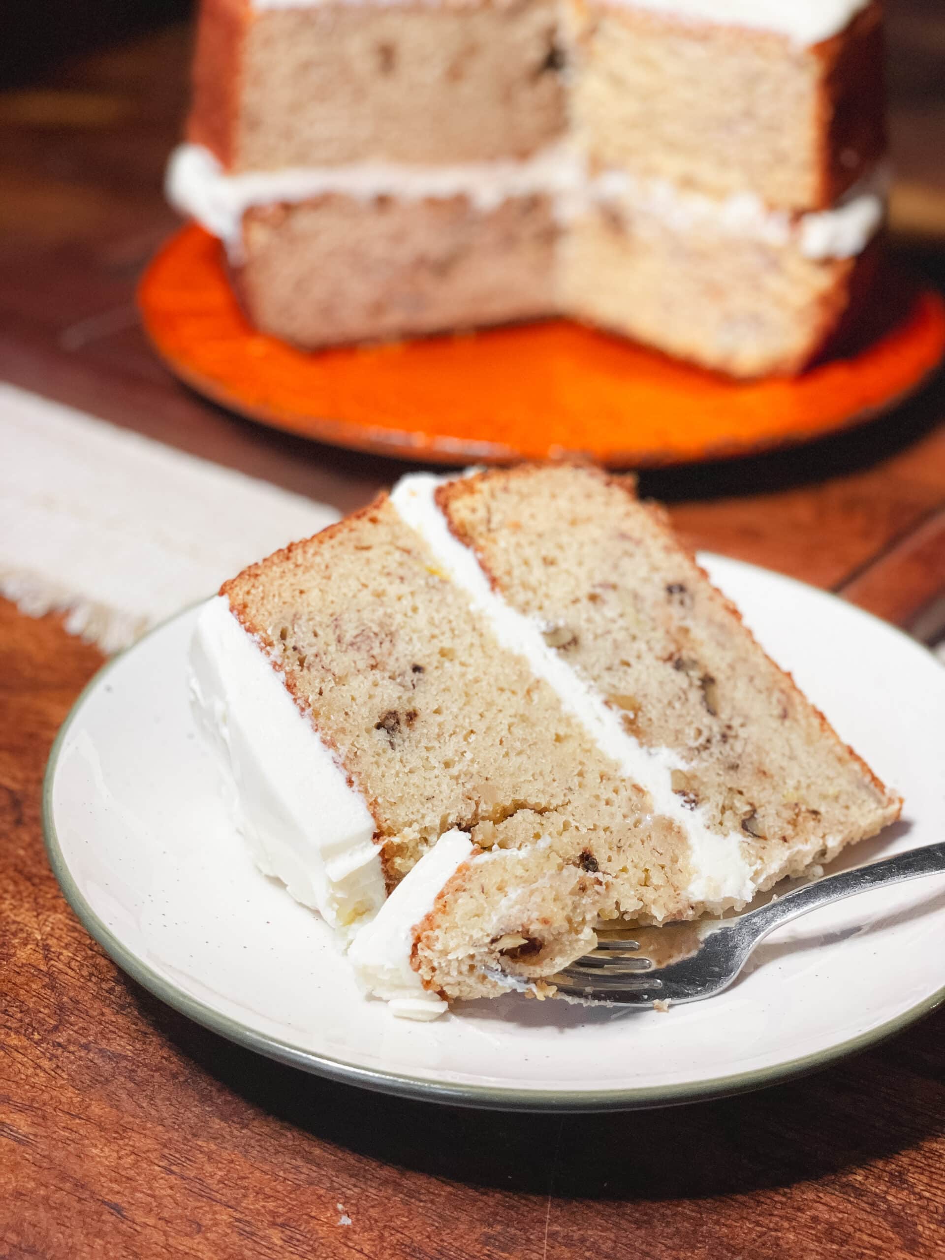 Banana cake on a white plate with a fork