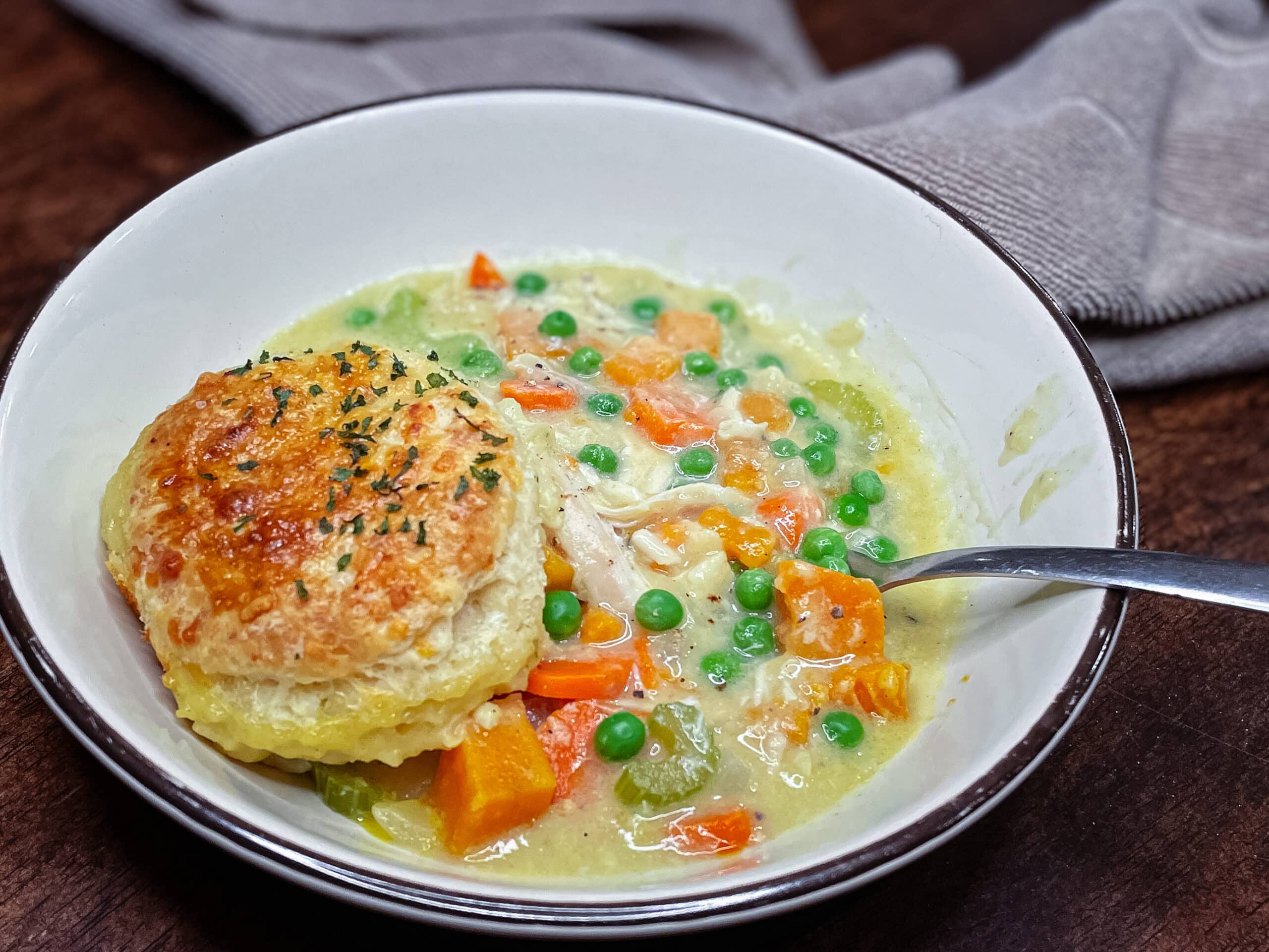 Chicken pot pie with biscuit in a bowl