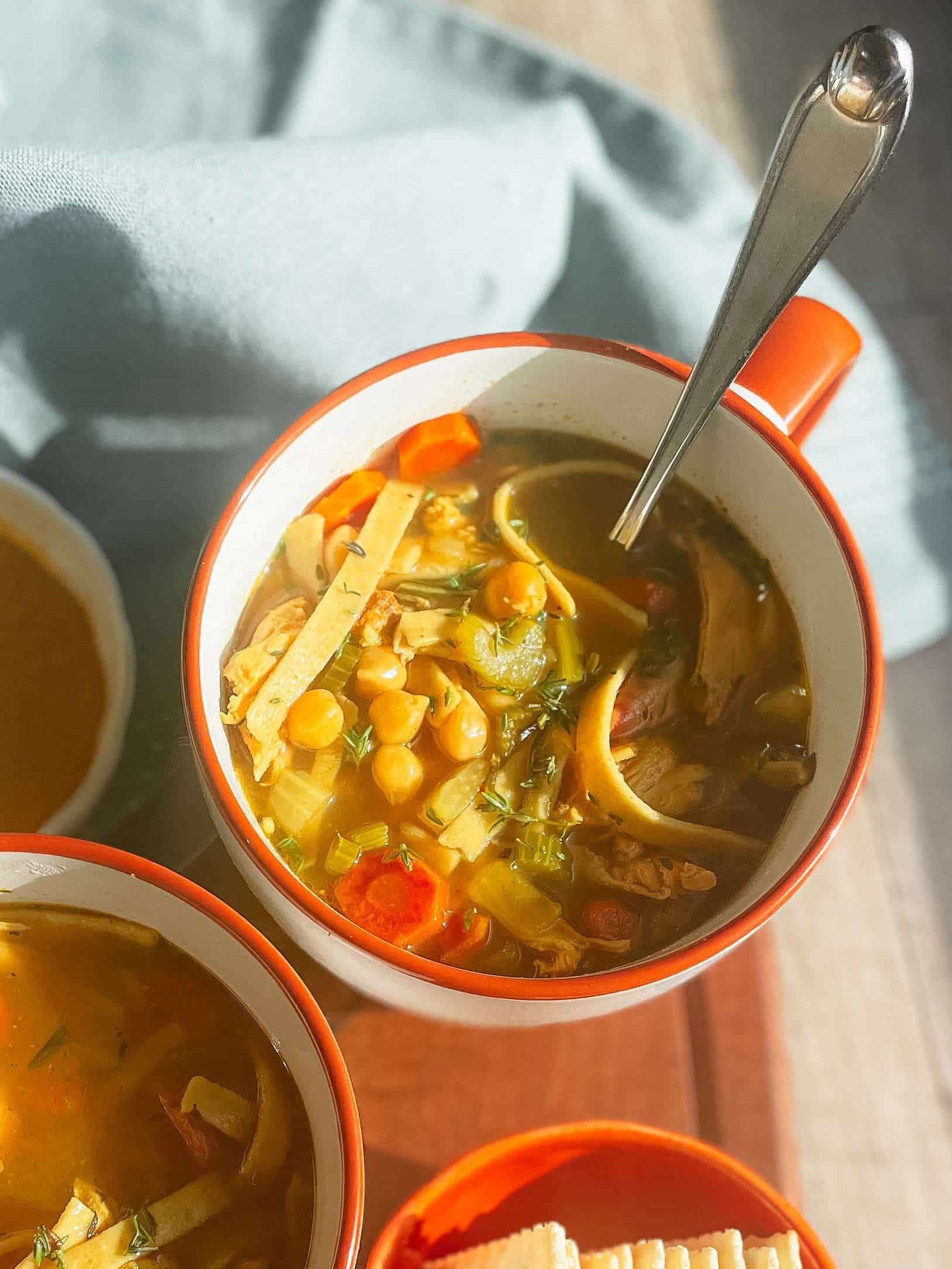 Chicken Noodles Soup in a white cup with an orange rim