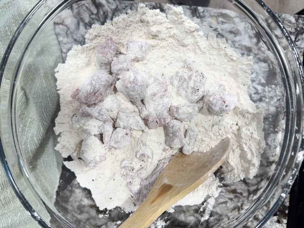 Stew Meat Coated in Flour for Beef Stew with Stew Meat in a Glass Bowl