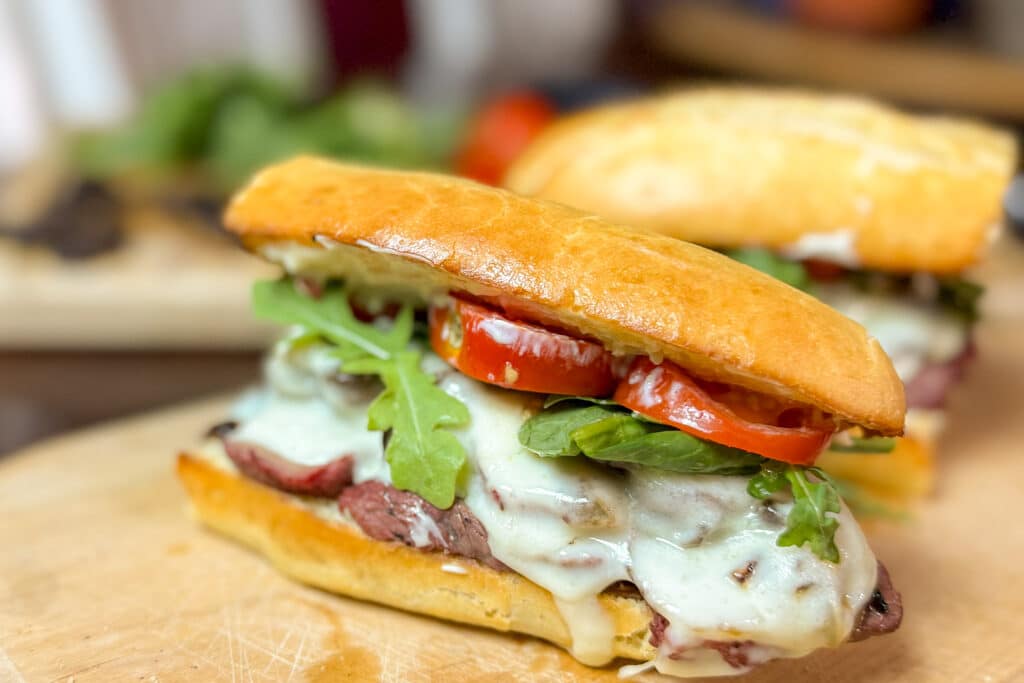 Steak Sandwich with Melted Provolone, Tomatoes, Lettuce, Onions, Mushrooms
