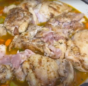 Putting Jerk Chicken Back on Rice and Veggies in Skillet