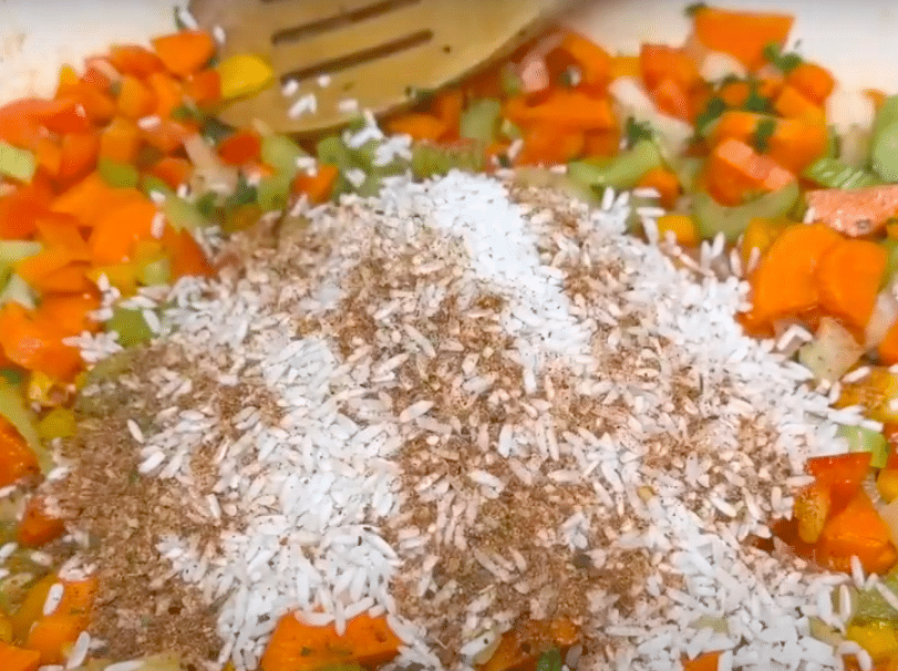 Adding Rice and Jerk Seasoning to Skillet with Veggies
