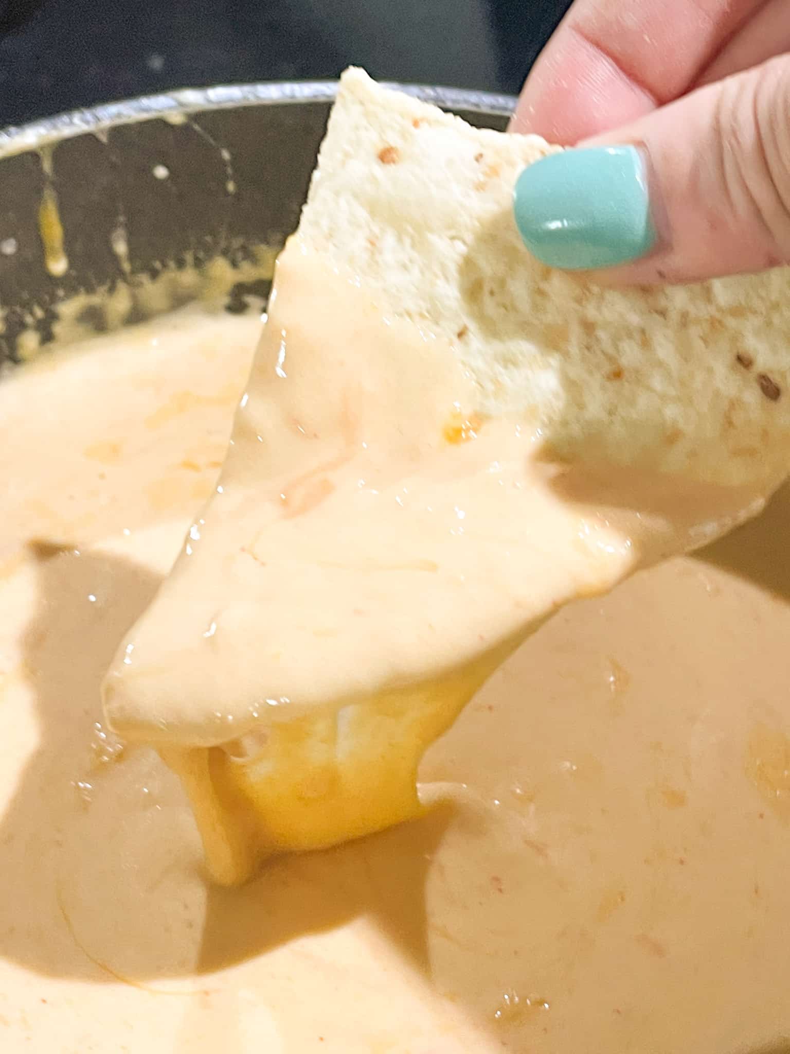 Nacho Cheese Sauce dripping from a chip