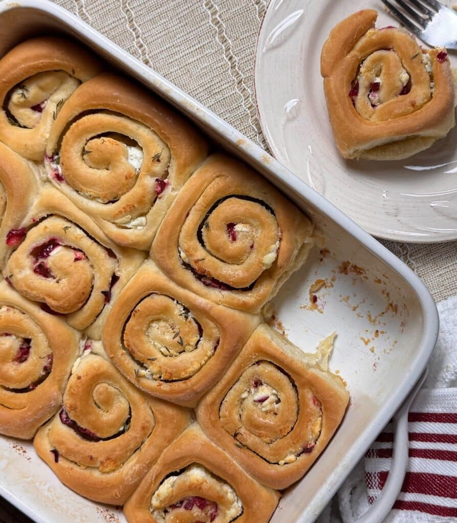 Cranberry Goat Cheese Dinner Rolls in Pan with One on Plate