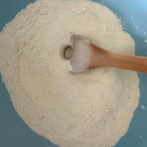 Dry Ingredients for Mexican Cornbread Combined in Blue Bowl