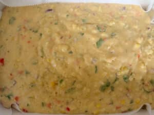Mexican Cornbread Batter Spread in a Casserole Dish