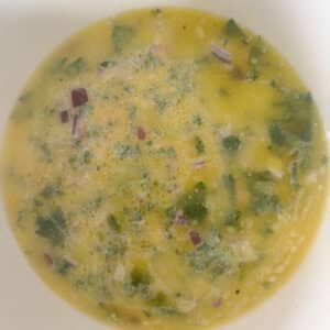 Wet Ingredients for Mexican Cornbread Batter Combined in White Bowl