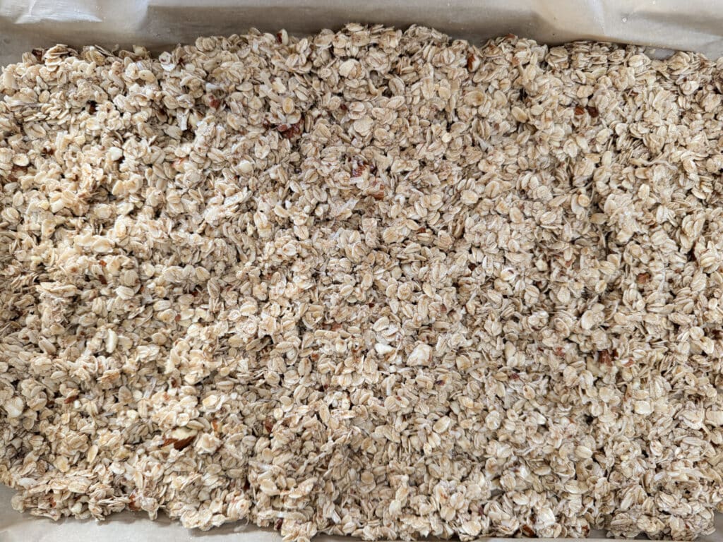 Spreading Granola on Cookie Sheet