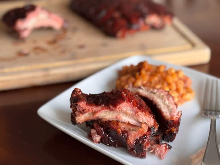 Close Up of Blackberry 321 Ribs with Beans Behind Them