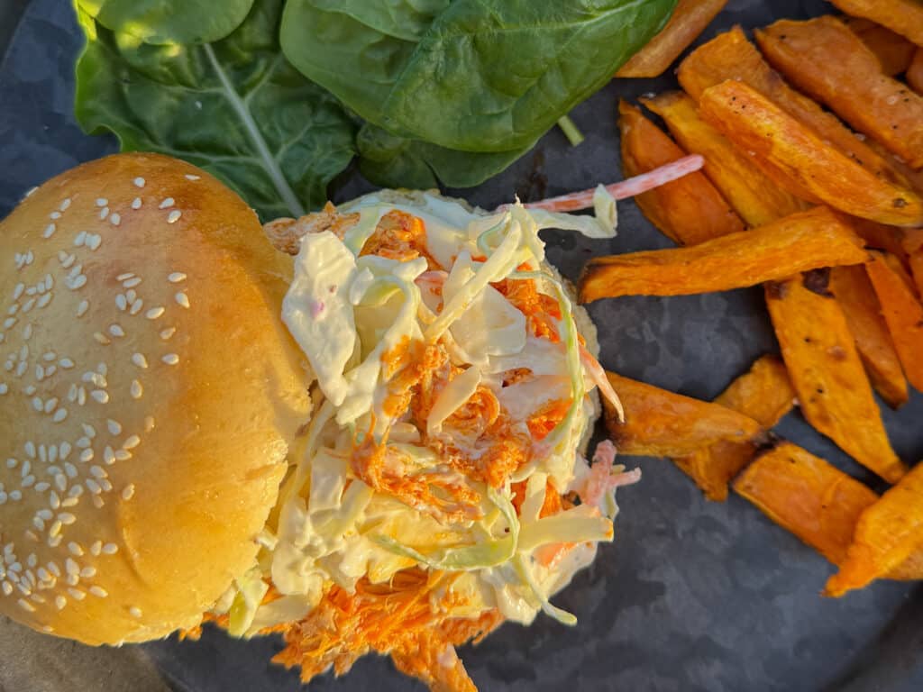Buffalo Chicken Burger with Cole Slaw on a Bun with Sweet Potato Fries and Lettuce