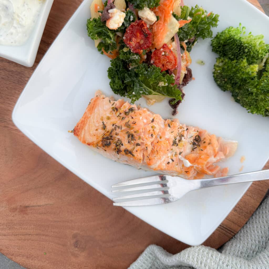 Lemon Garlic Baked Salmon on a Plate with Broccoli and a Salad