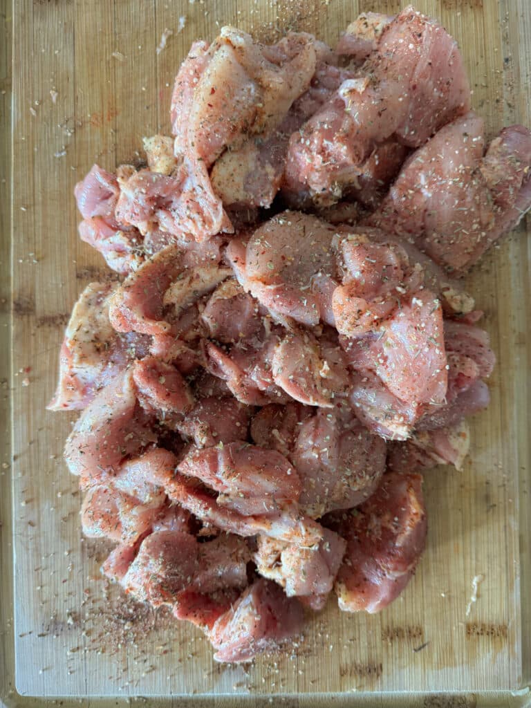 Cut Up Chicken Thighs with Cajun Seasoning on Them