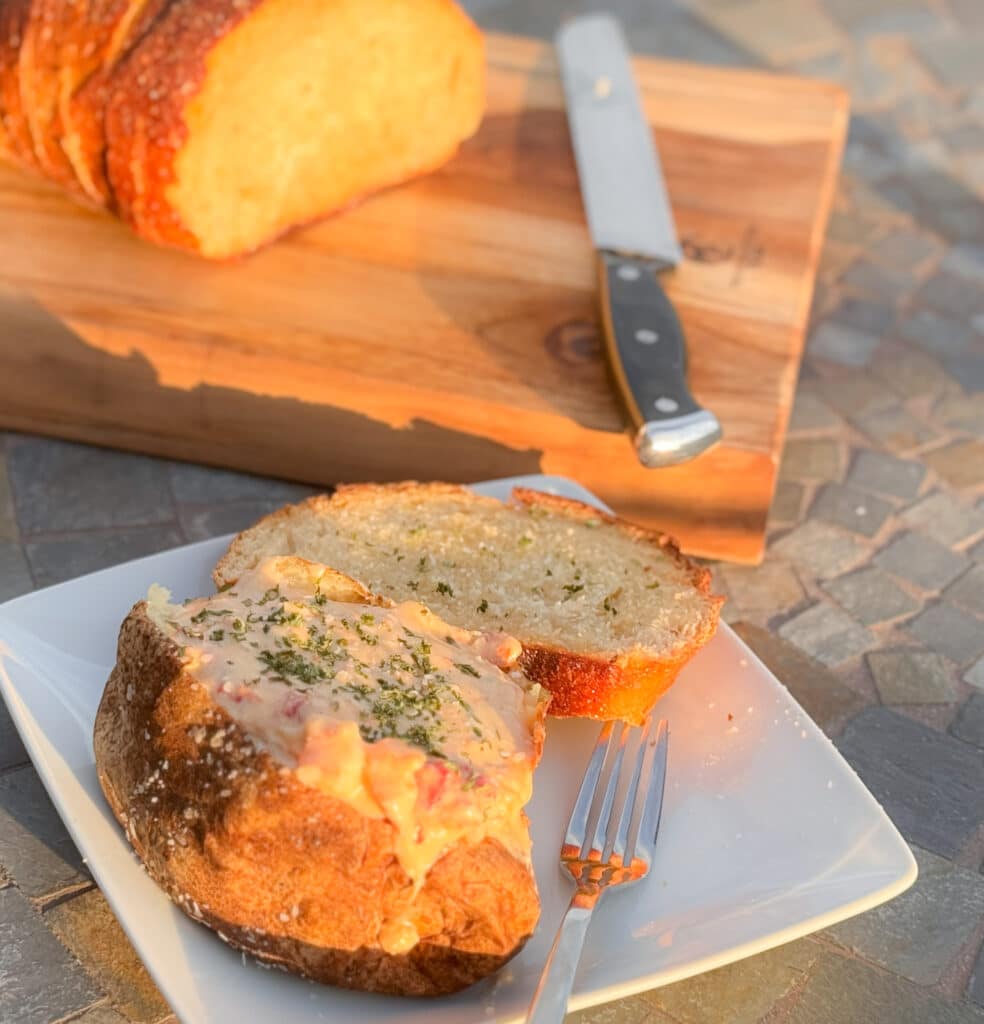 Seafood Stuffed Baked Potato with Garlic Bread on Plate
