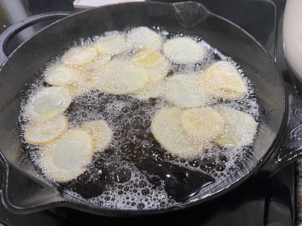 Thinly Sliced Potatoes Frying in Beef Tallow