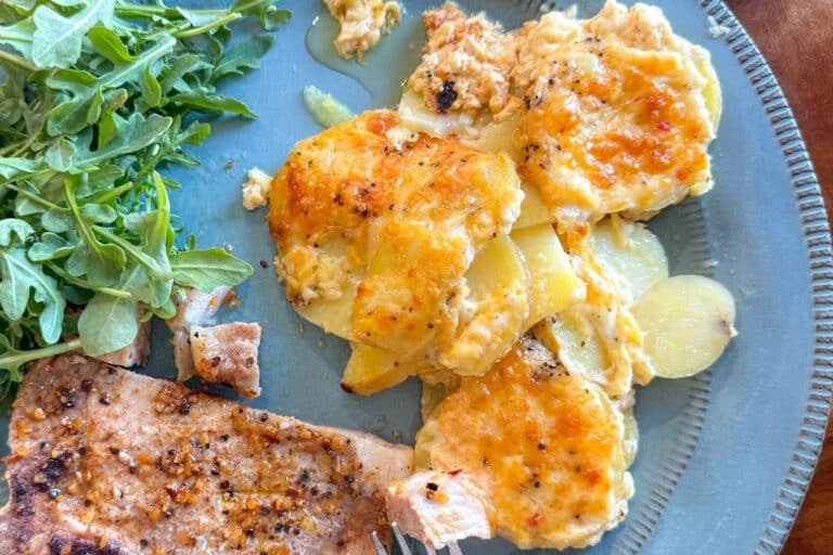 Scalloped Potatoeson a Blue Plate with a Pork Chop