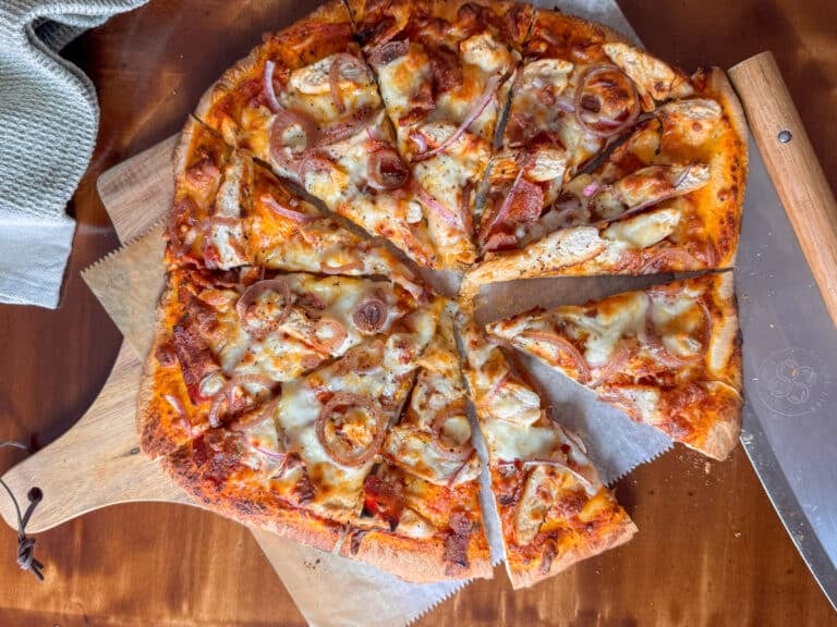 Sliced Chicken Bacon Ranch Pizza on Cutting Board