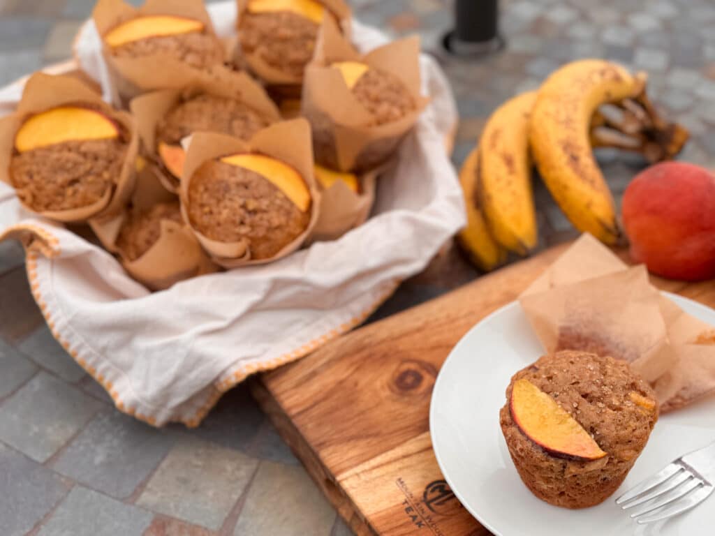 Peach Banana Oat Muffins in a Bowl and One on a Plate