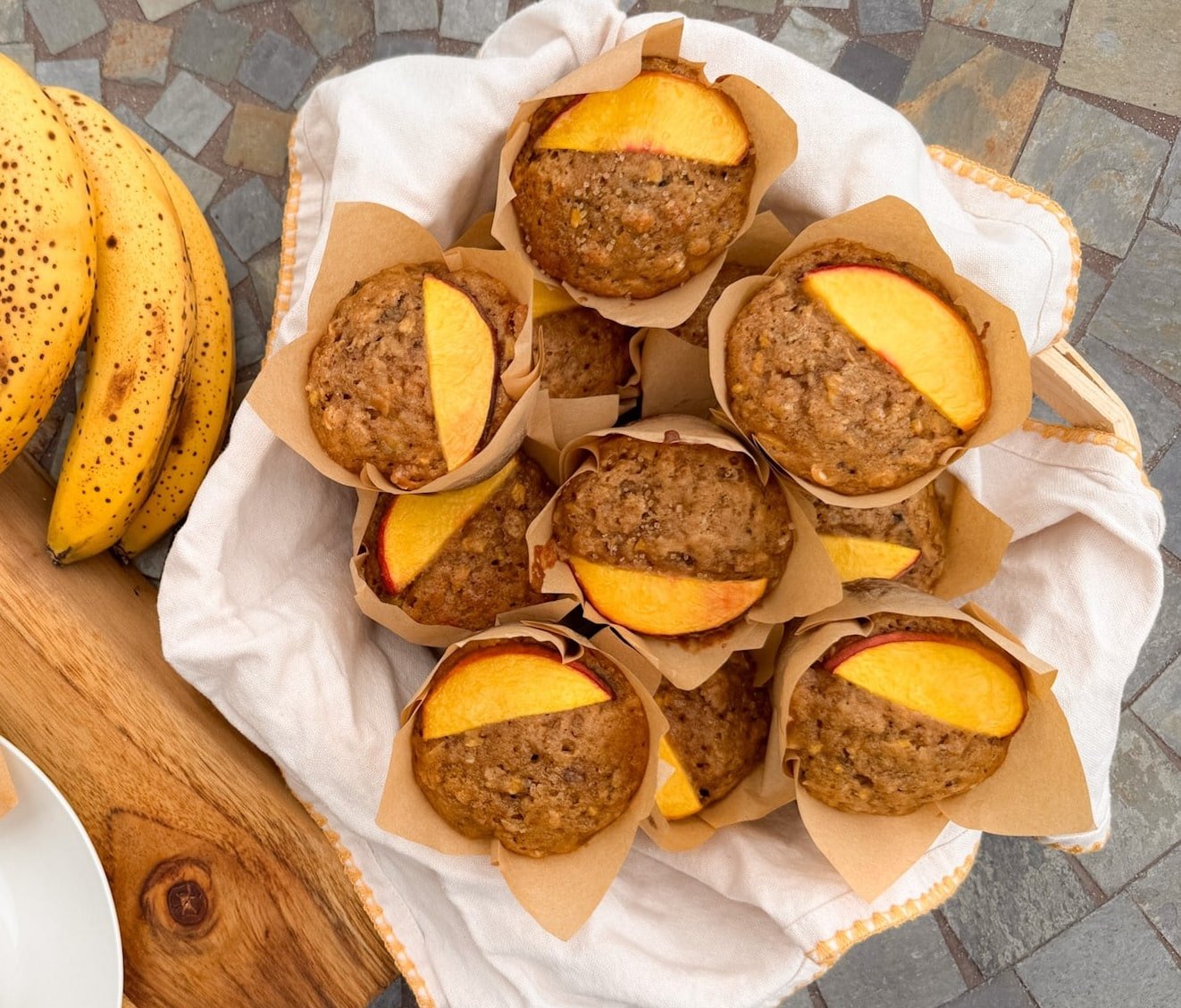 A basket of Peach Banana Oat Muffins