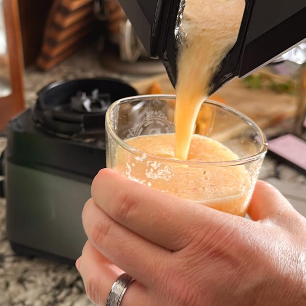 Pour Peach Bourbon Margarita into a Glass