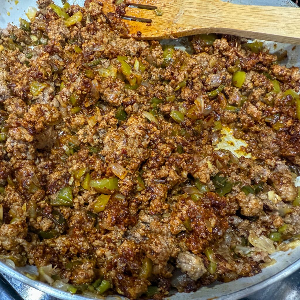 Ground Beef, Onions and Peppers Seasoned with Taco Seasoning in Skillet