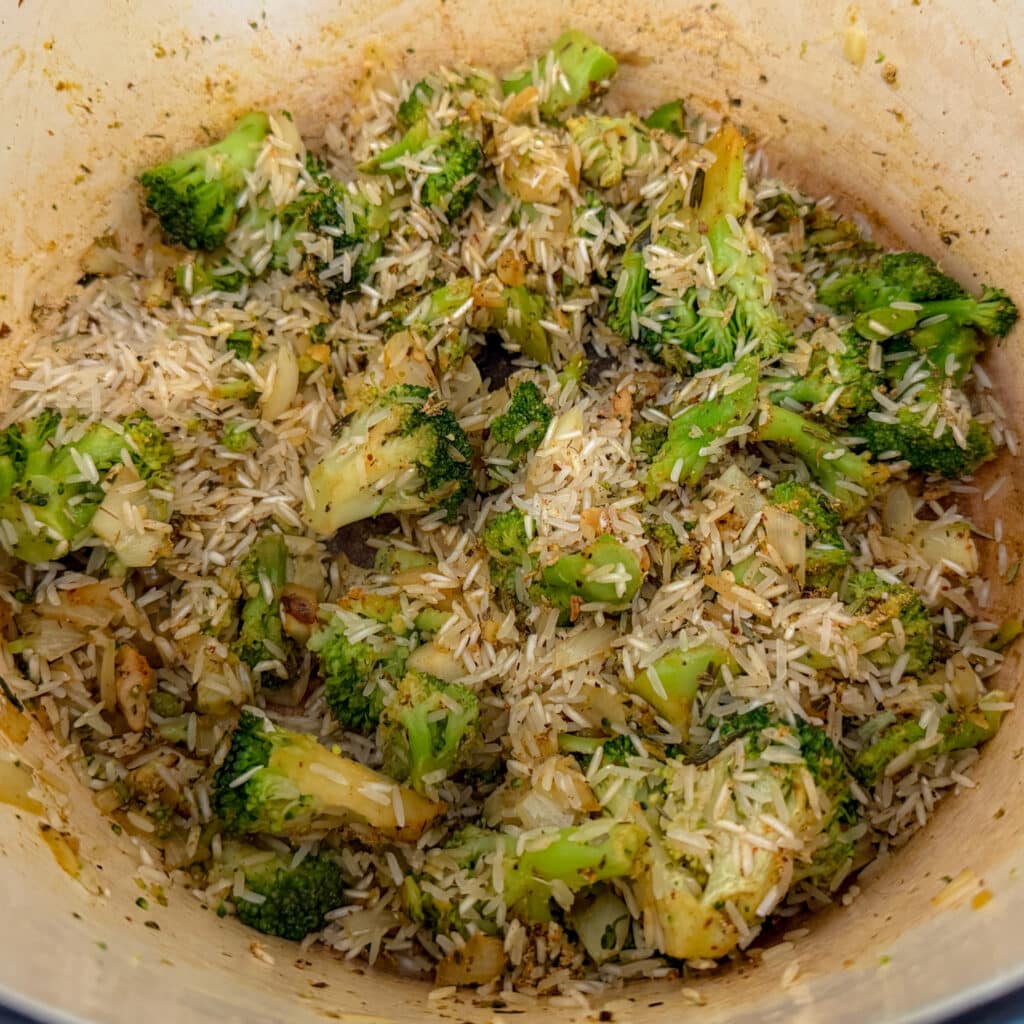 Adding Rice and Seasonings to Cheesy Chicken Broccoli and Rice