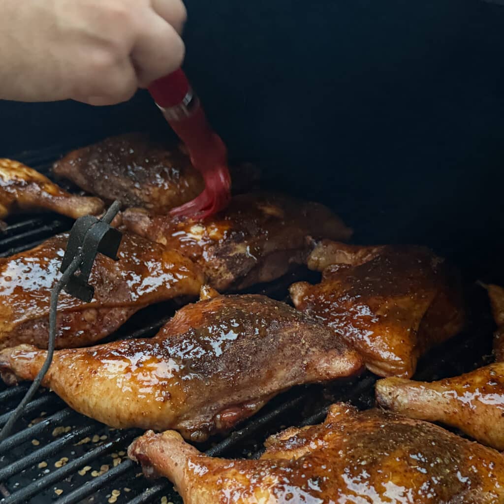 Bbq Chicken Quarters Being Glazed