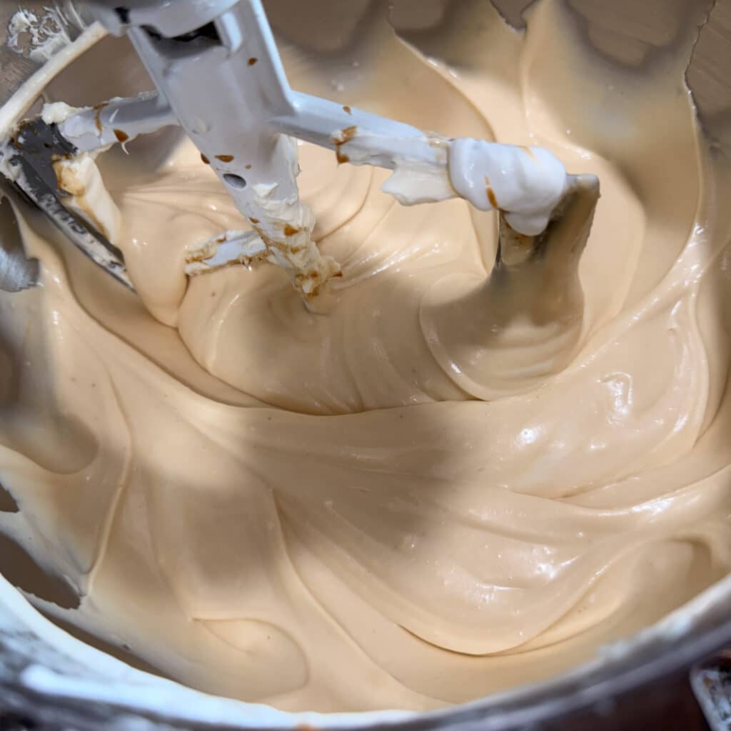 Melted Cookie Butter Blended into Cheesecake Filling
