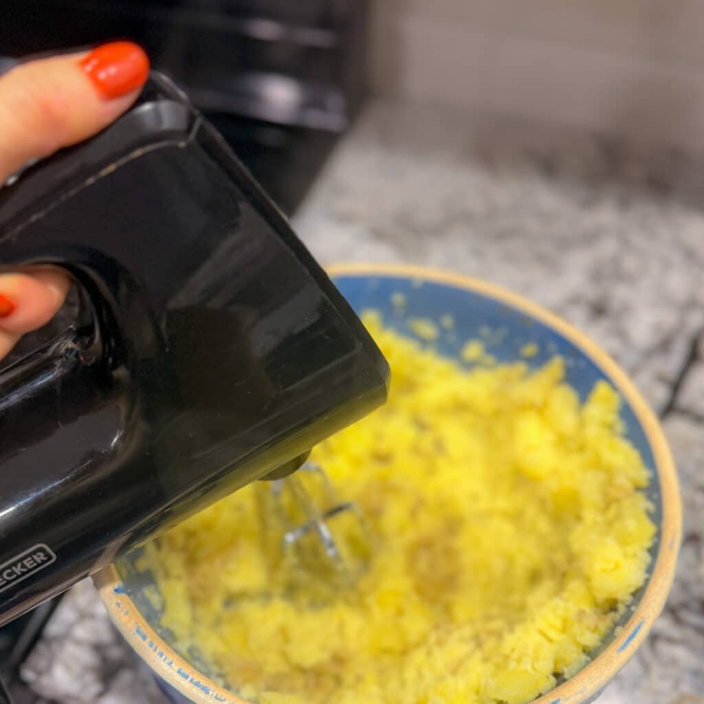 Mashing Poatoes in a Bowl with a Hand Mixer