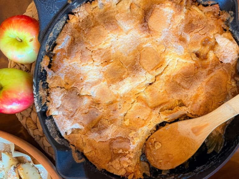 Apple Pie Dump Cake Baked in a Cast Iron Skillet with a Golden Brown Cake Topping and Apple Filling